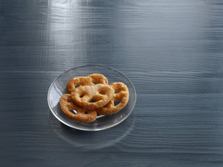 Homemade cookies on a transparent glass plate on a wooden table