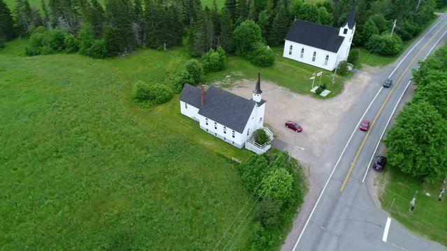 Aerial of small white churchs in the rural countryside next to each other