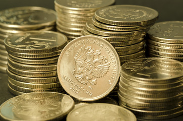 Stack of Russian coins. Coat of arms on a coin in the center close-up