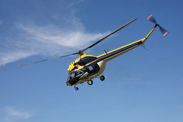 Fototapeta na wymiar Aircraft - Black-yellow helicopter flight at low height