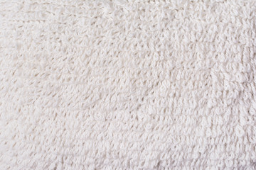 Hand knitted ecru background. Fabric texture