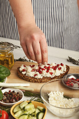Woman making tasty bruschettas for healthy snack, closeup