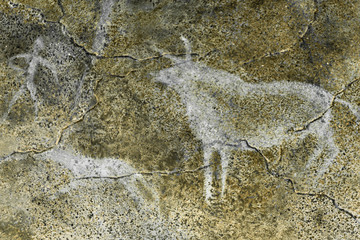 drawing of hunting on the wall of the cave. ancient history. archeology.
