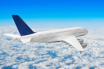 Fototapeta na wymiar Passenger huge liner airplane fly above clouds and blue sky.