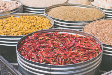 Dried chili peppers and other spices in open market store
