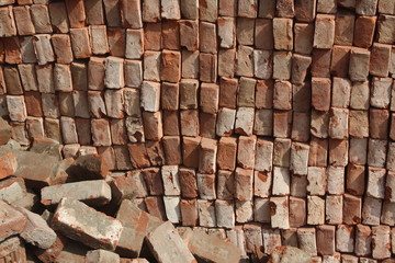 brick pile in a under construction site for office & industry structure. Many people involved in brick export import. A brick is building material used to make walls, pavements and others