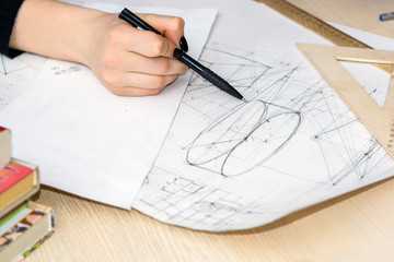 Close up Architect hand drawing sketches, blueprints. Architectural-engineering study concept