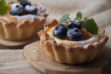 Shortbread baskets with curd cream, apricot and blueberry