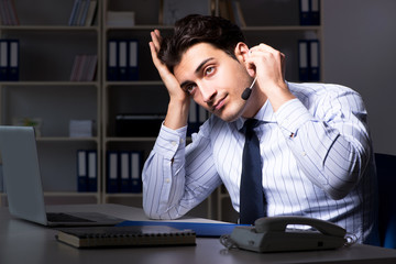 Tired and exhausted helpdesk operator during night shift