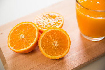 Glass of orange juice and slices of orange fruit