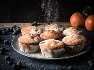using sugar to decorate fresh baked muffins or cupecakes