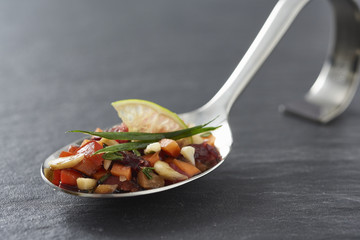 little delicious appetizer on a happy spoon