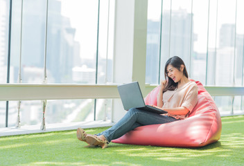 Asian woman using laptop celebrated success