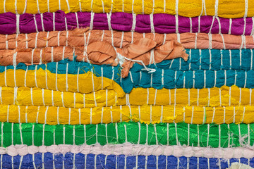 Unusual abstract knitted background texture of fabric of different colors.