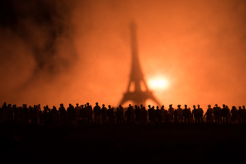 Silhouettes of a crowd standing at field behind the blurred foggy background. Revolution, people...