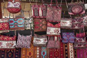 Fototapeta premium colorful fabrics and other folk products at a roadside stall with traditional Armenian colors and patterns