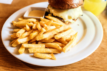 meat and cheese burger with french fries