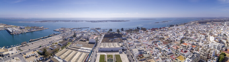 Fototapeta na wymiar Aerial daytime view of Olhao downtown and Marina seascape, waterfront to Ria Formosa natural park. Algarve.