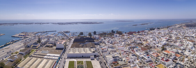 Aerial daytime view of Olhao downtown and Marina seascape, waterfront to Ria Formosa natural park. Algarve.