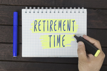 hand writing on notepad: retirement time
