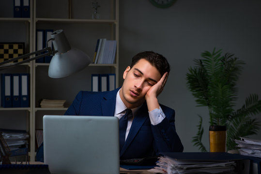 Businessman tired and sleeping in the office after overtime hours
