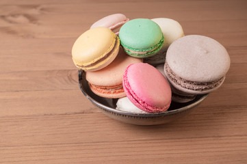 Colorful French macaron or Italian macaron stack on basket.