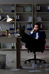 Businessman tired and sleeping in the office after overtime hour