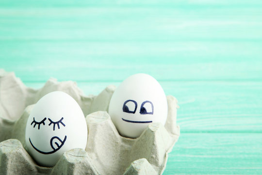 Eggs with funny faces in carton package