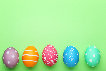 Colorful easter eggs on green background