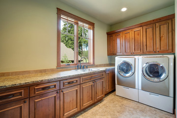 Huge laundry room with white washer and dryer