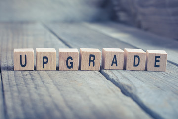 Closeup Of The Word Upgrade Formed By Wooden Blocks On A Wooden Floor
