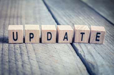 Macro Of The Word Update Formed By Wooden Blocks On A Wooden Floor