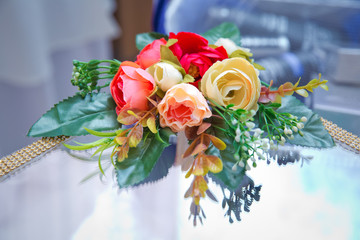 Artificial red, yellow rose bouquet . Artificial flowers decorative background