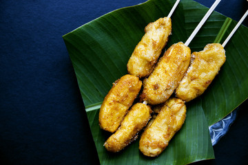 Philippine dessert banana cue. Golden banana on stick served for food.