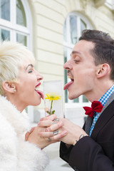 woman and man  that sucks with the language a block of ice ,with yellow flower