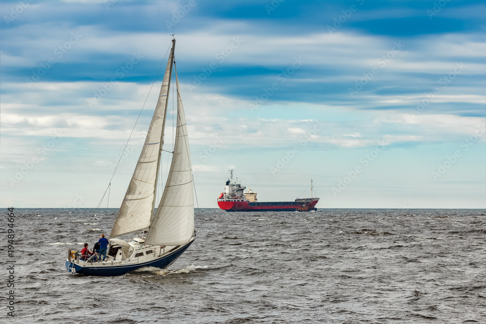 Wall mural Blue sailboat at journey