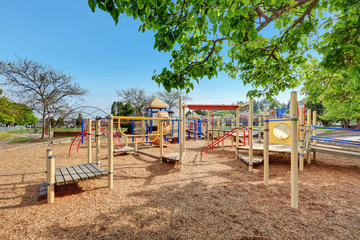 Fototapeta na wymiar Alki Playground with children run, slides and swings.