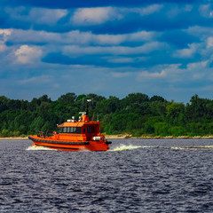 Orange pilot boat in action