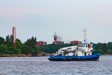 Blue tug ship underway