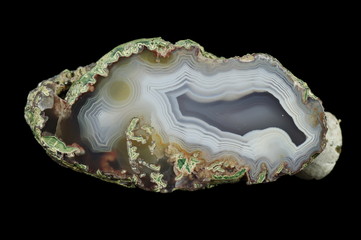 Cross section of the agate. Multicolored silica rings colored with metal oxides are visible....