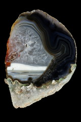 cross section of agate. Multicolored silica rings colored with metal oxides are visible. Horizontal...