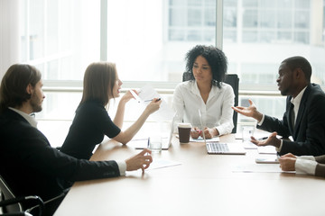 Diverse business partners arguing about bad contract at meeting in lawyers office, disgruntled...