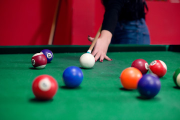 Girl is playing billiard