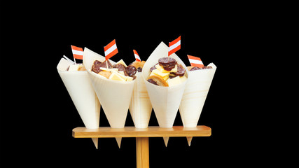 The snack, variation of cheese and sausages in the paper cone at street food farmers market....