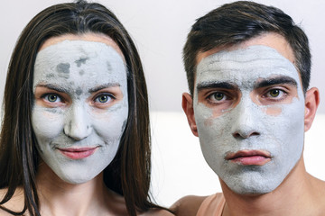 Emotional large portrait of a married couple in masks for the face of clay. day Spa, Wellness, skincare