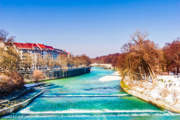 View on winter landscape and turquoise Isar in Munich