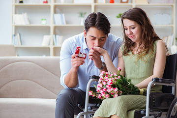 Man making marriage proposal to disabled woman on wheelchair