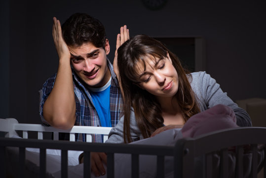 Young parents sleepless with newborn baby at night