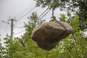 Delivery and unloading of building stone by truck with a crane
