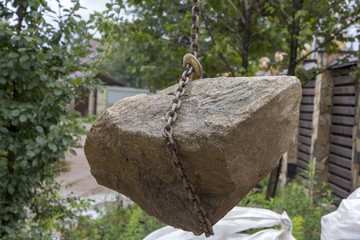 Delivery and unloading of building stone by truck with a crane